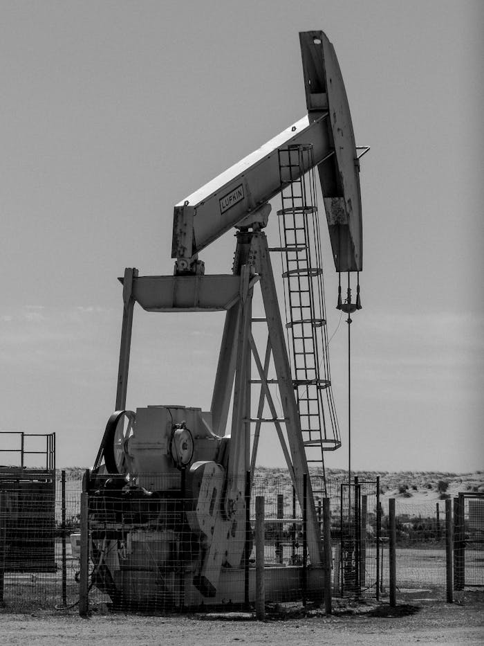 Monochrome image of an oil pumpjack, illustrating energy extraction in an industrial landscape.